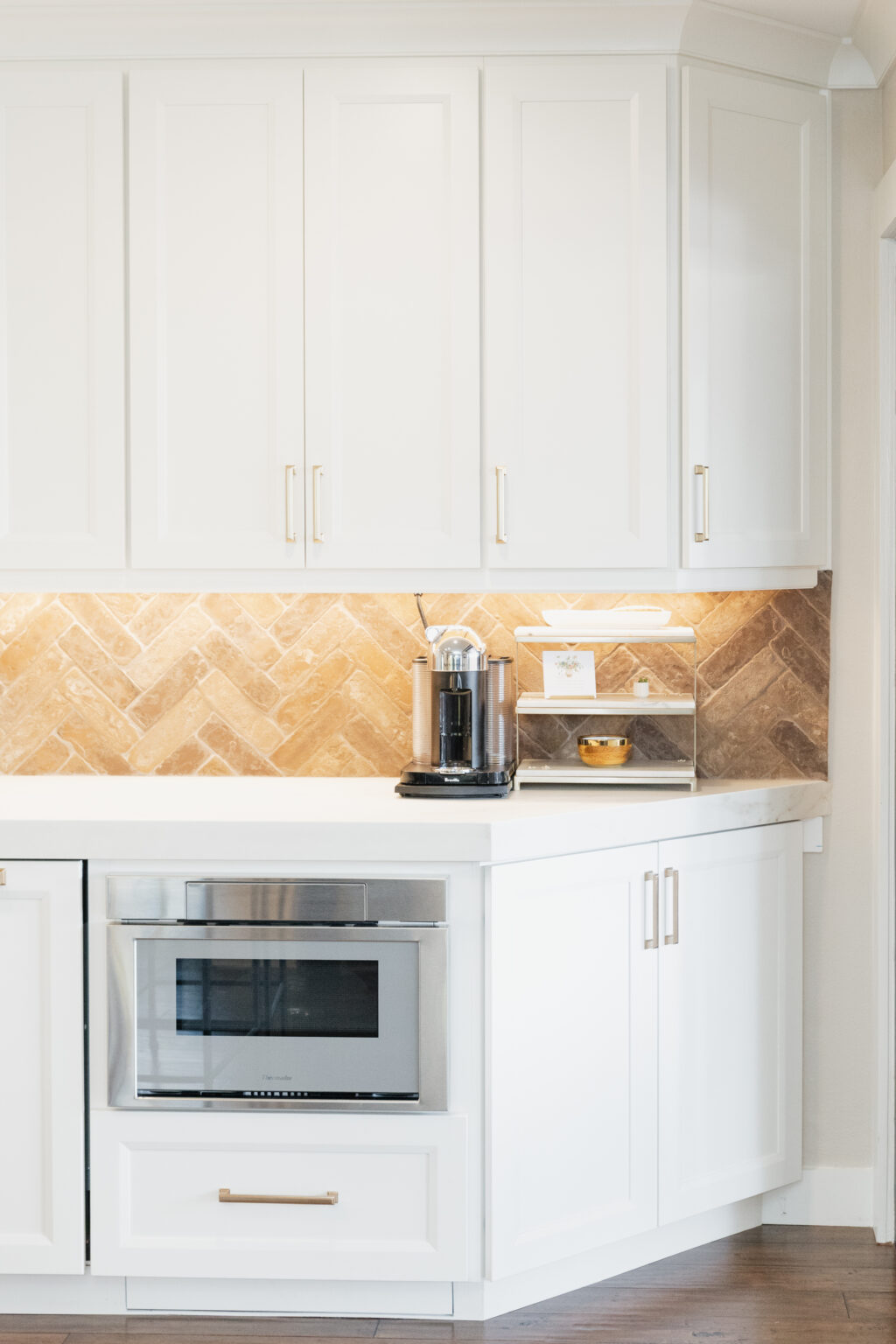 White Kitchen with Herringbone Backsplash by Home Remodeling Center